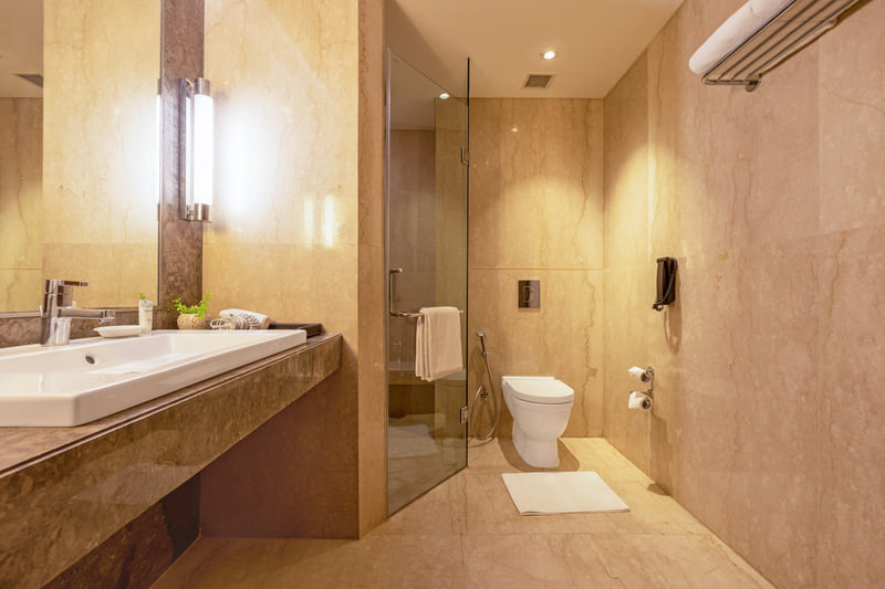 Standard King Room bathroom with walk-in shower at The Anya Hotel, Gurugram