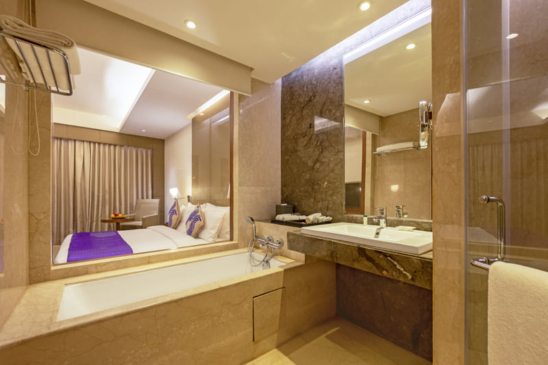 Superior Room bathroom with bathtub at The Anya Hotel, Gurugram
