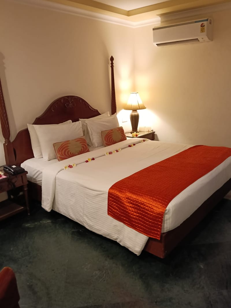 Deluxe room interior with side sea view at The Hans Coco Palms, Puri