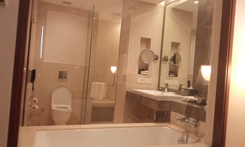 Superior Room bathroom with bathtub at The Anya Hotel, Gurugram