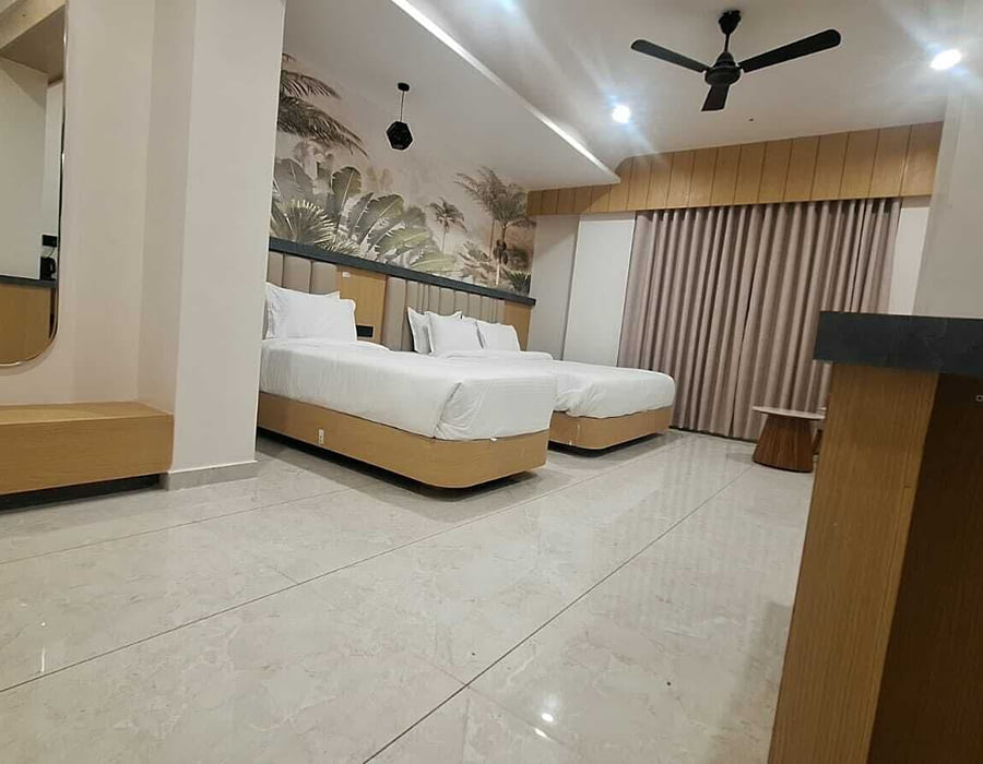 The Family Interconnected room at Hotel Shree Radhe By White Panda, with two beds, a mirror on the side wall