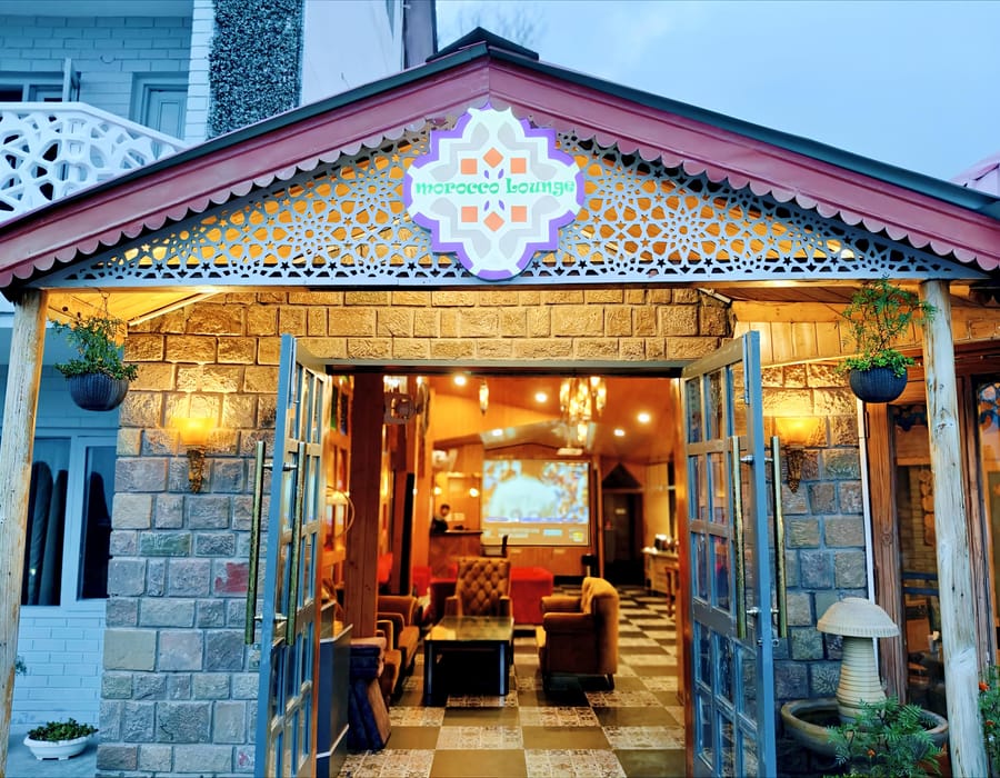 The stone-fronted restaurant and bar building at Levelup The Heritage Kud, its pitched roof and signage above the glass doors