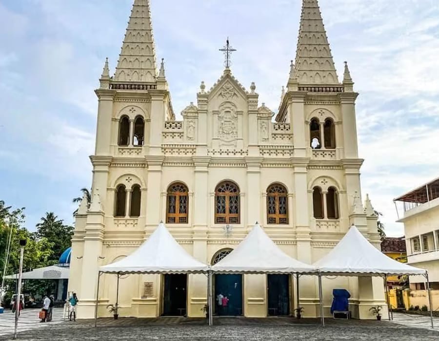 Santa Cruz Cathedral Basilica with white and pastel façade and twin spires against the sky, Fort Kochi