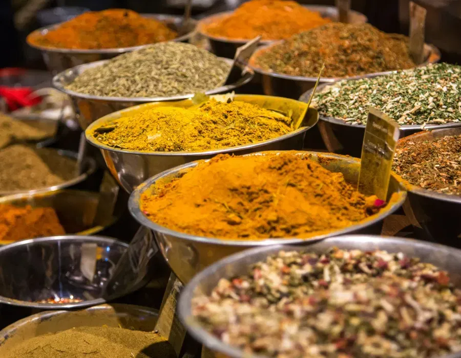 Open sacks of colourful spices and dried goods lining a shopfront along Mattancherry's Bazaar Road, Kochi