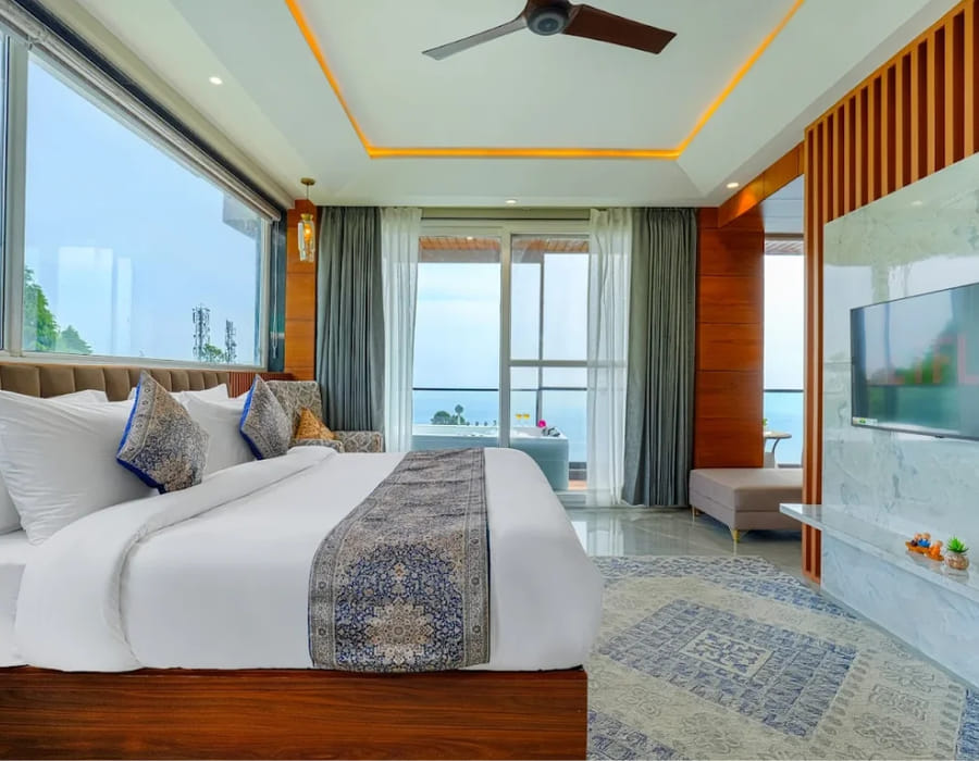The Family Suite with Mountain View at White Panda Hotel Divine Peaks, with a wide window over the valley, a patterned rug