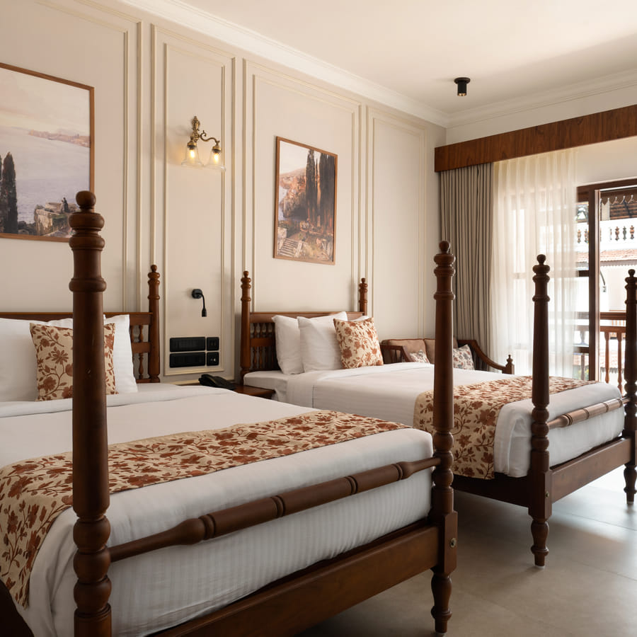Pool View Twin Room with two four-poster twin beds and pool-side balcony doors, Sanskreti