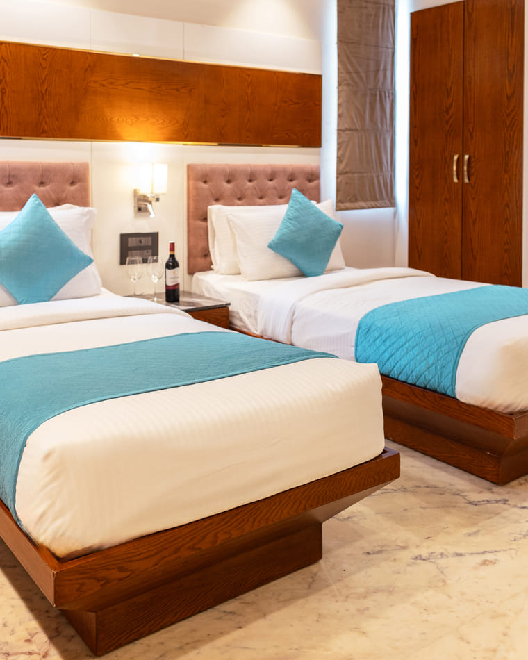 A serene, light-filled guest room at KSN Signature, Jaipur