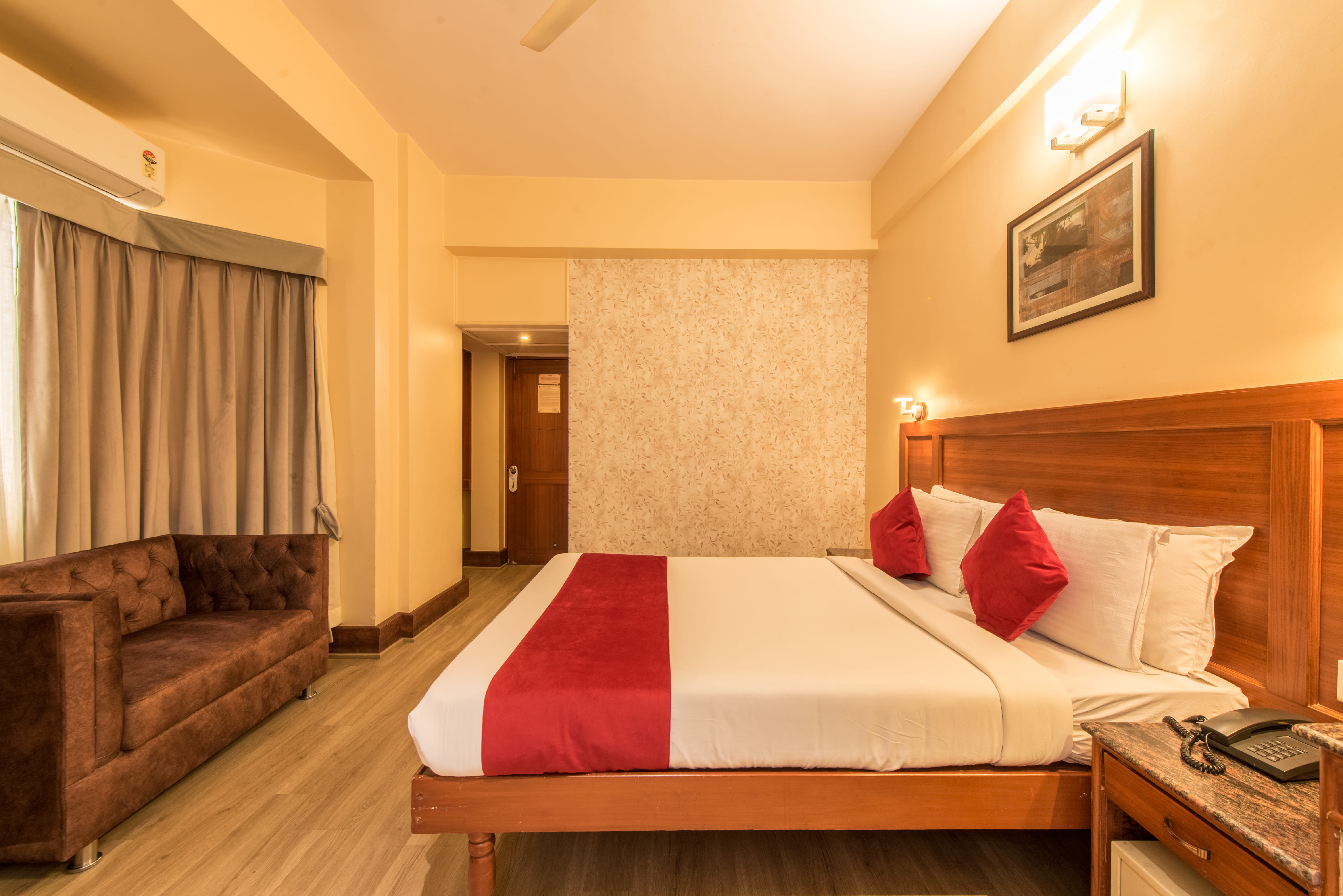 Diamond Executive Room at Bangalore Gate Hotel, wooden floors, double bed with warm furnishings
