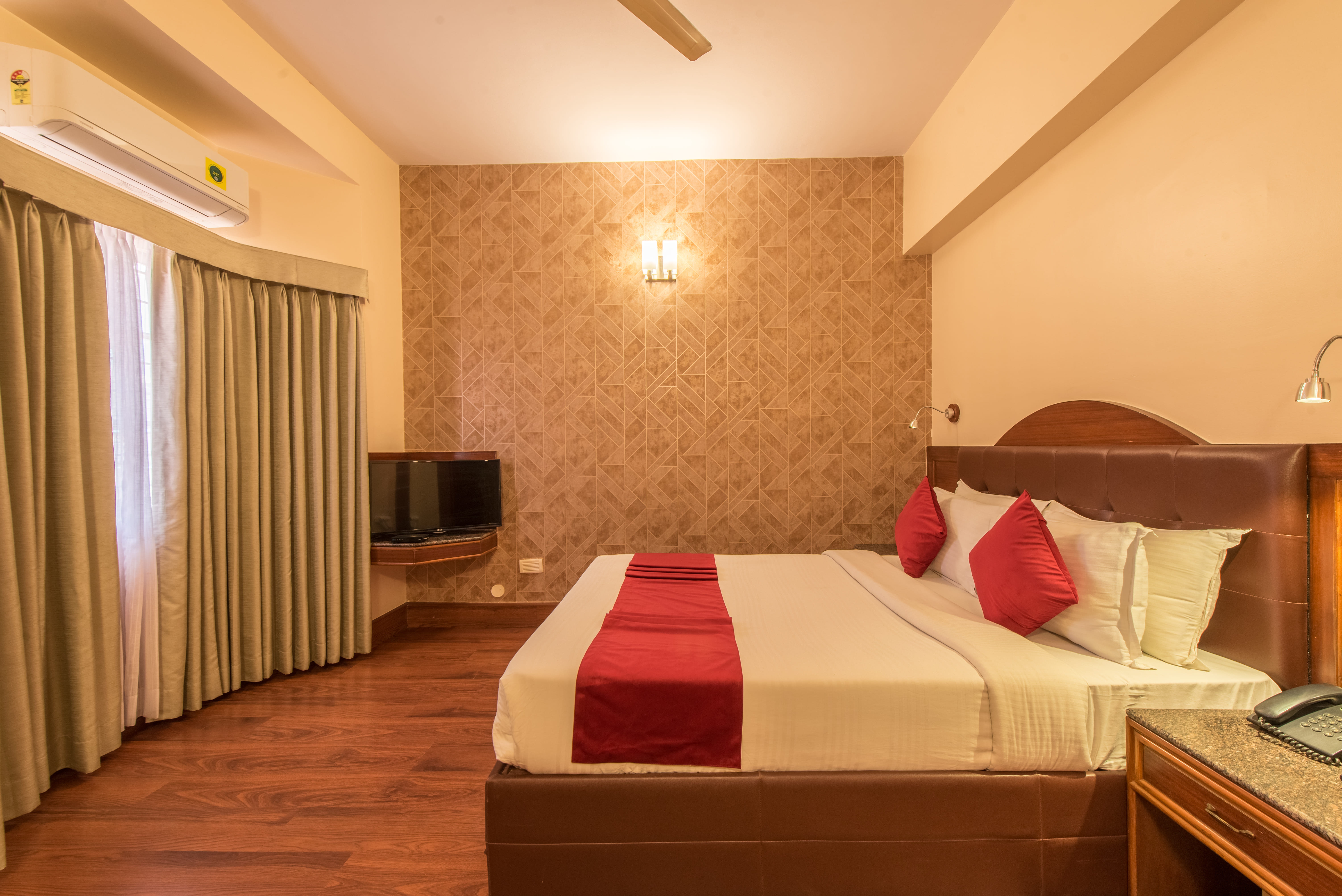 Platinum Deluxe Room at Bangalore Gate Hotel, warm terracotta accent wall and premium furnishings