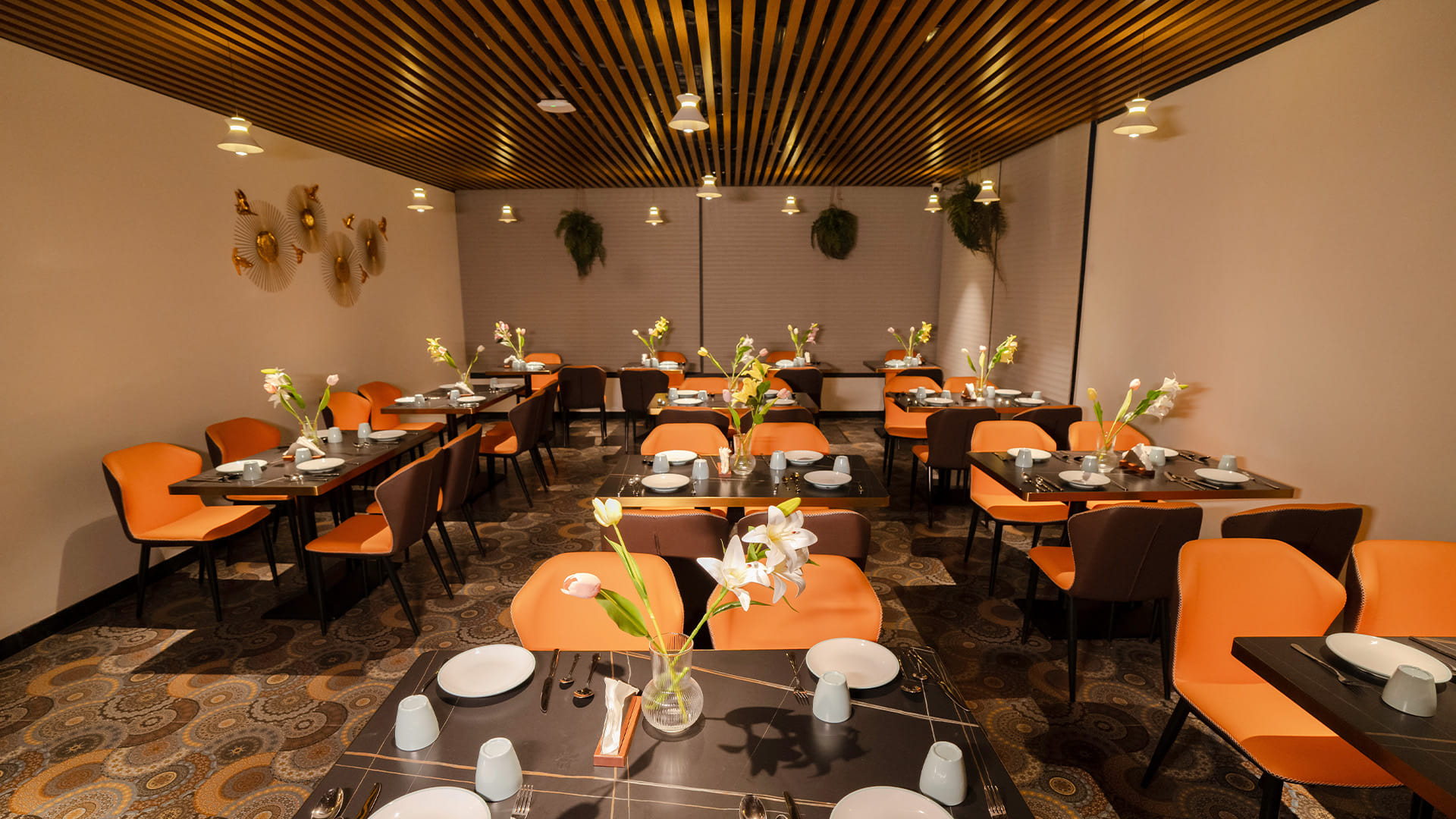 Wide view of the dining hall at Hotel Ritvi's Elite with the breakfast counter visible beyond