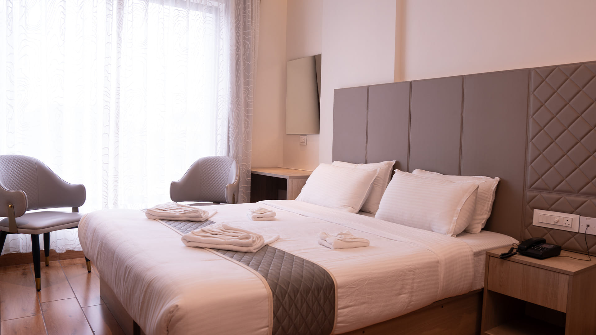 Royal King Room with a king bed and a diamond-quilted headboard