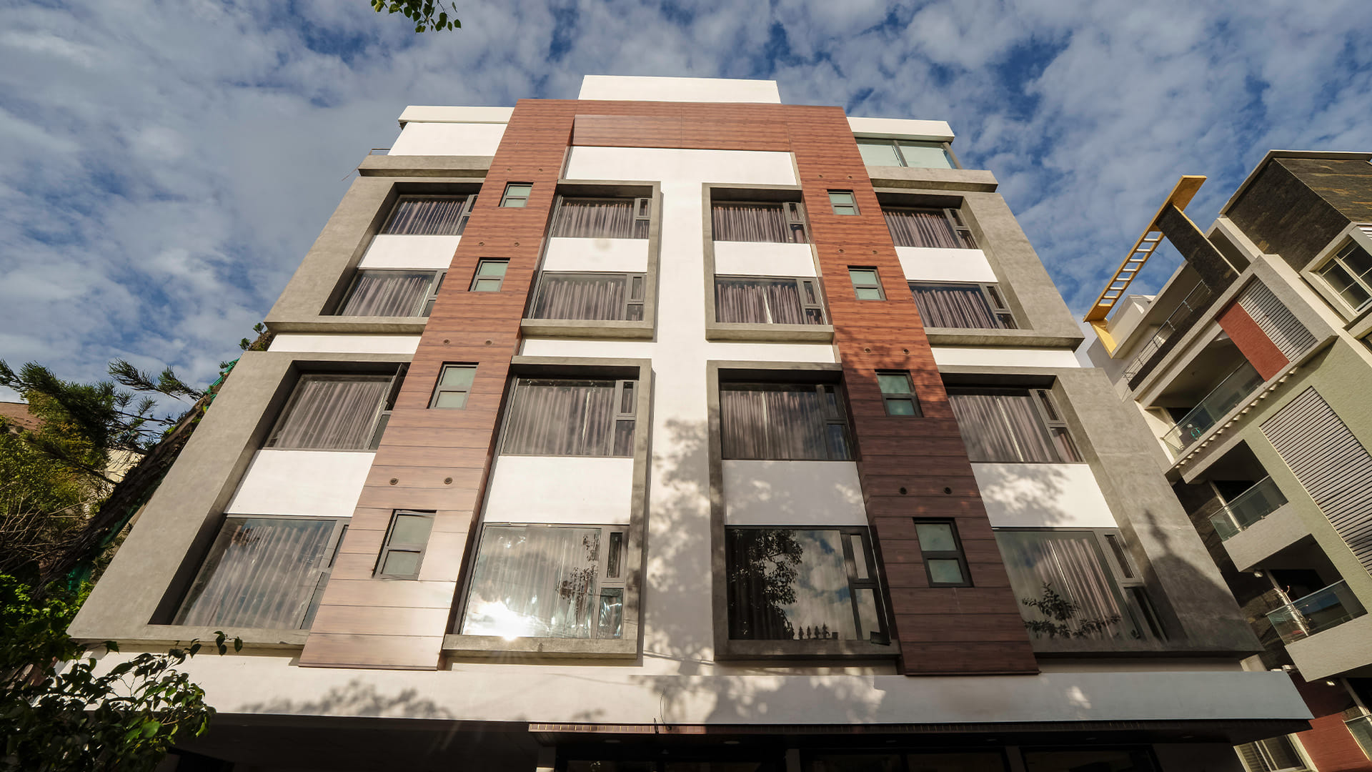 Low-angle daytime view of Hotel Ritvi's Elite's upper floors against the sky