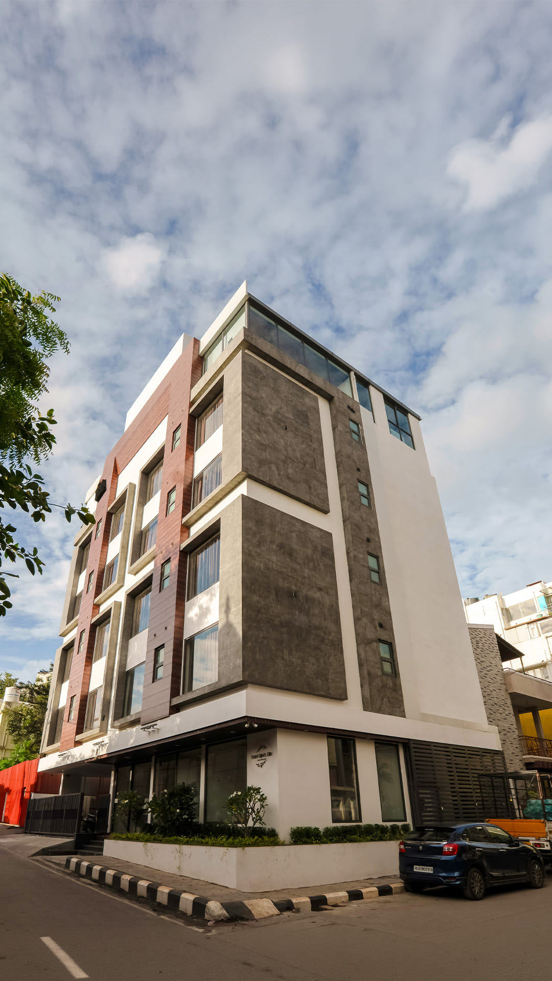 Hotel Ritvi's Elite seen from the street corner against a bright sky