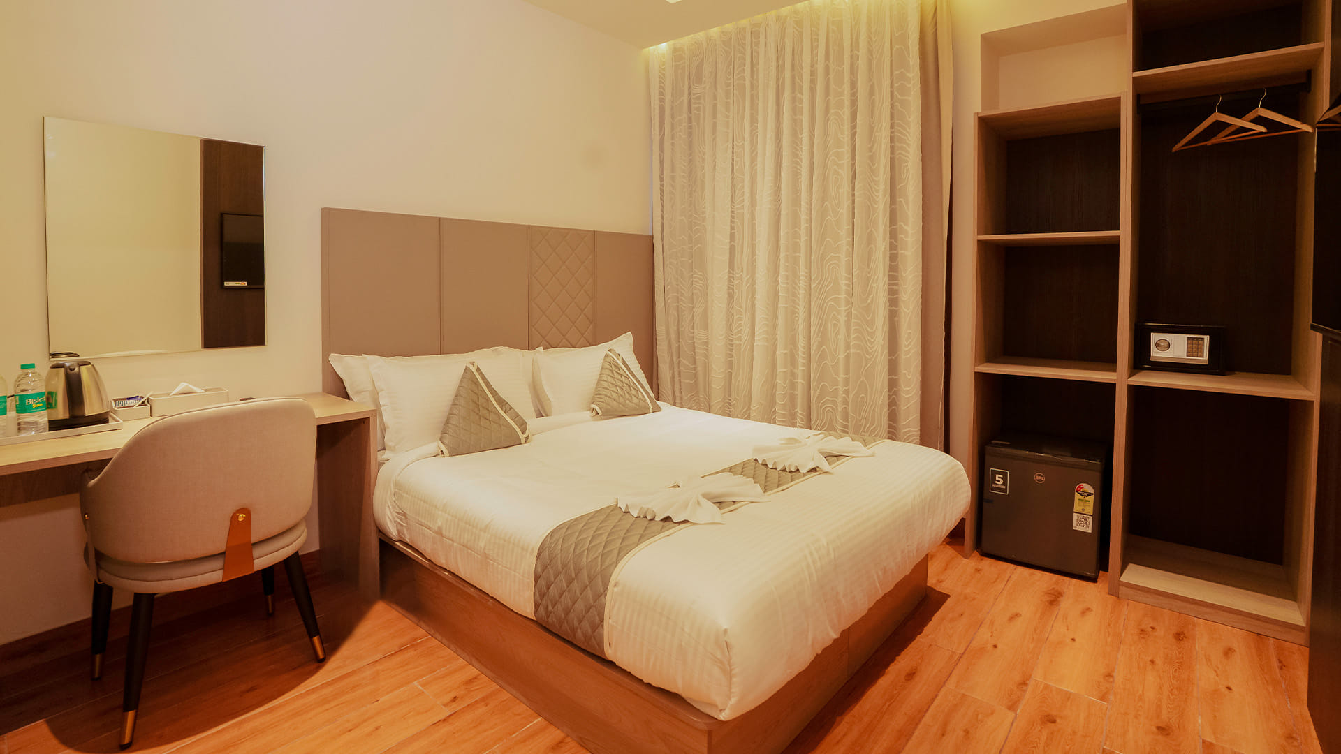 Classic Queen Room with a queen bed, a work desk, and an open wardrobe with a safe