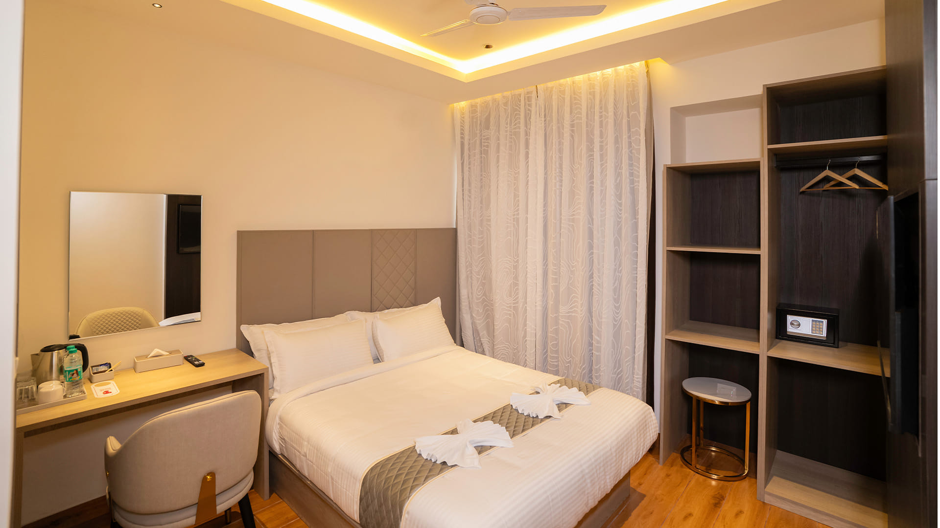 Classic Queen Room with a queen bed, a ceiling fan, and an open wardrobe with a safe