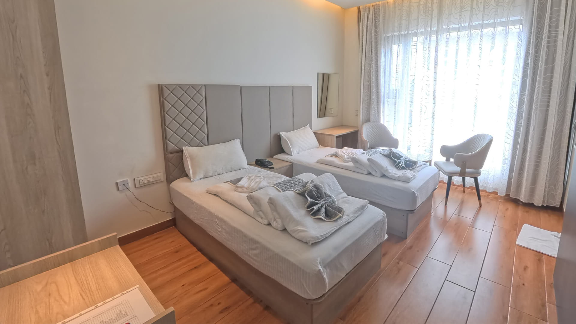 Executive Twin Room at Hotel Ritvi's Elite with two beds and two armchairs near the window