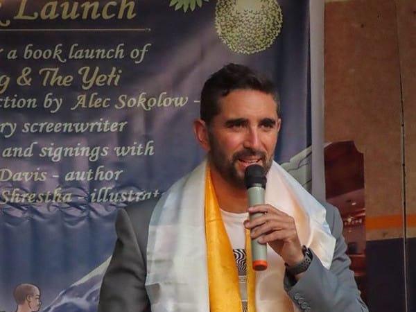 Oscar-nominated screenwriter Alec Sokolow, draped in a white and gold khada scarf, speaking at the Machig and the Yeti book launch held at Nepali Ghar Hotel.