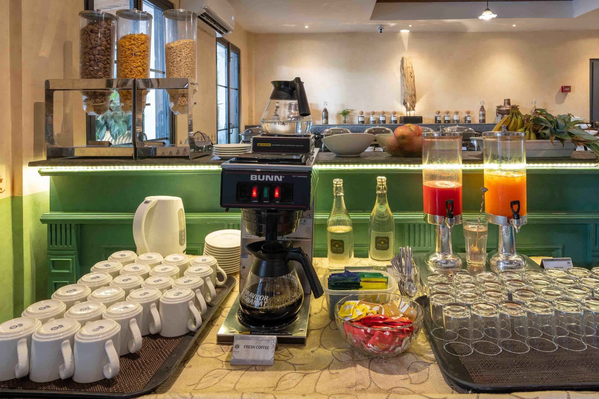 The all-day breakfast buffet at Chiya Pasal restaurant, Nepali Ghar Hotel, laid out with fresh brewed coffee, cereals, and a row of chilled juices each morning.