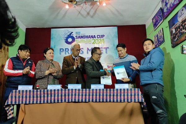 Two men signing an MOU document at a press meet for the Samjhana Cup 2024, an event hosted in the Baithak meeting room at Nepali Ghar Hotel in Kathmandu, Nepal.