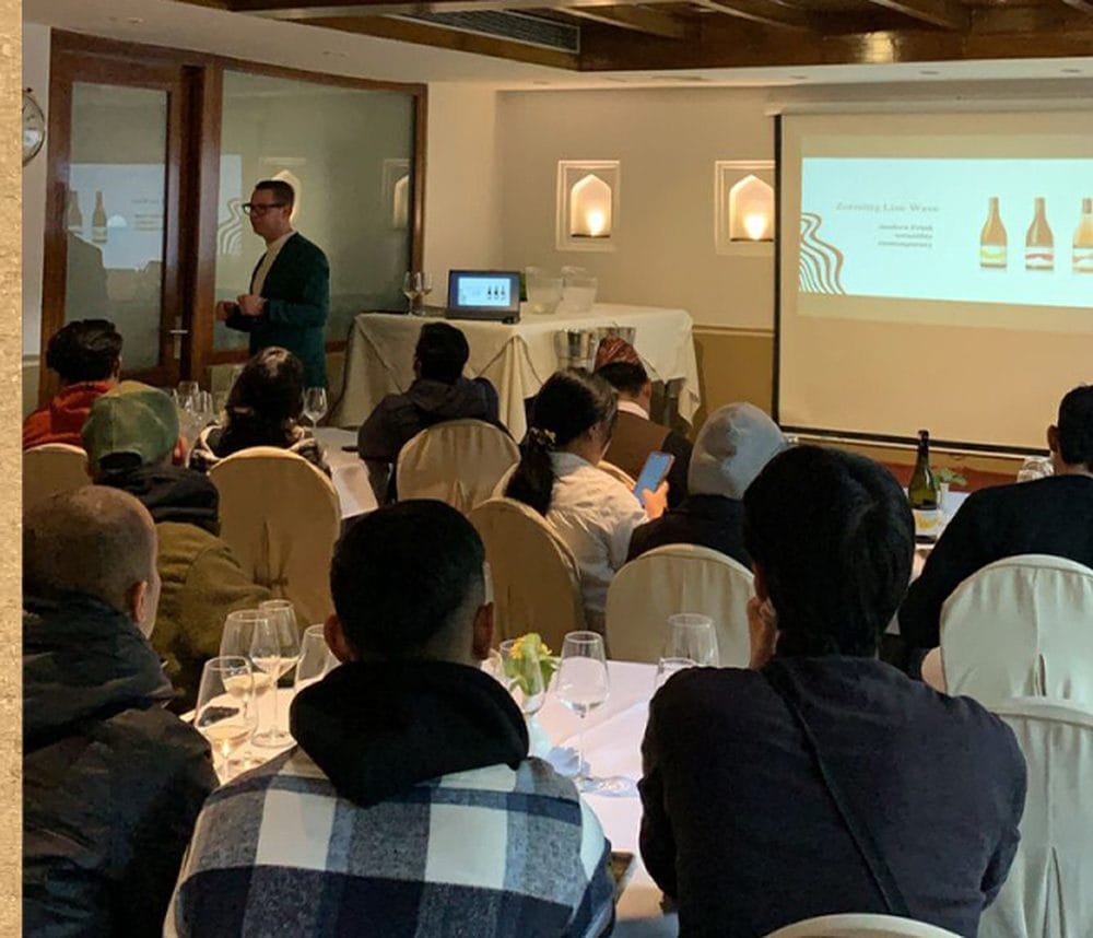 A corporate training session under way in the Baithak meeting room at Nepali Ghar Hotel, with guests seated at long tables while a presenter speaks nearby.