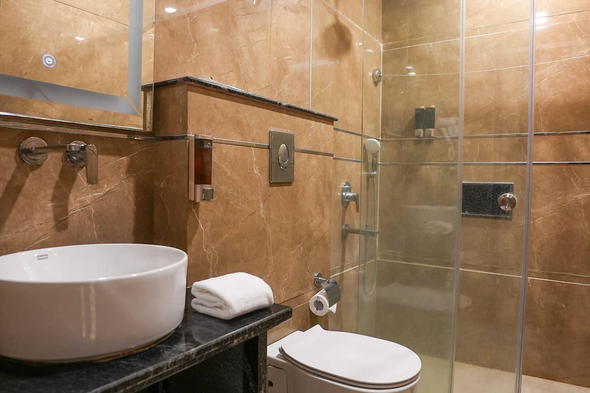 Washbasin and shower in an Executive Room bathroom