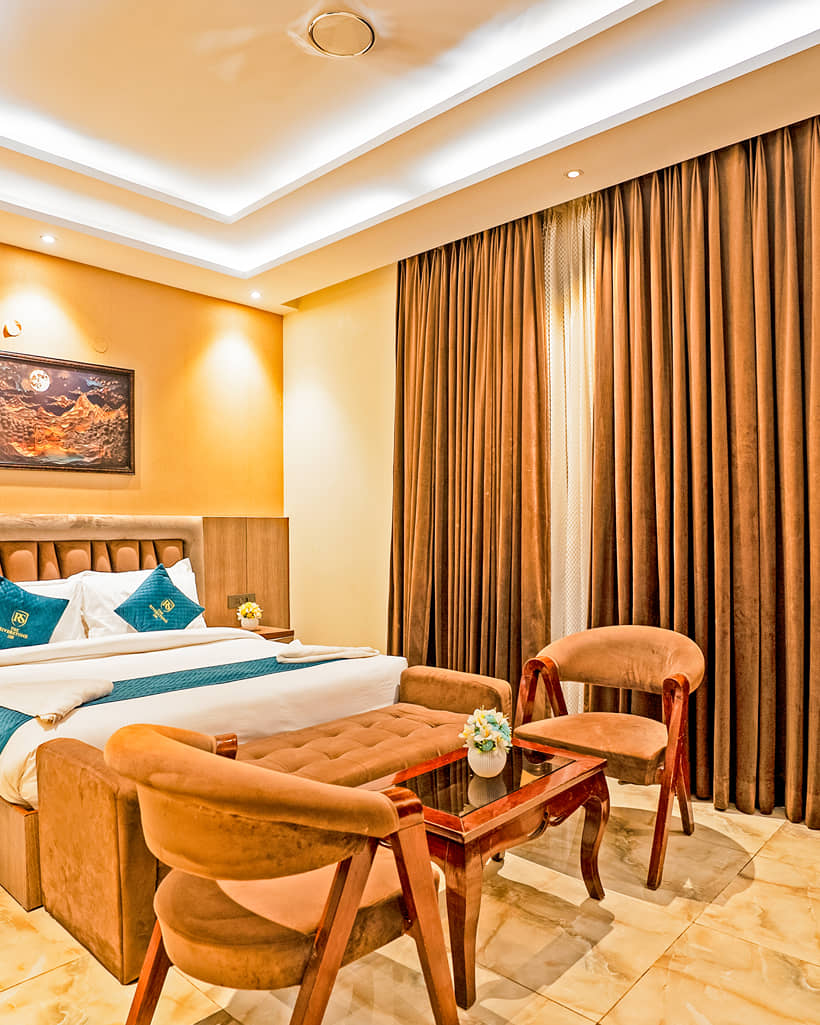 Bed and a seating area with table and chairs in an Executive Room