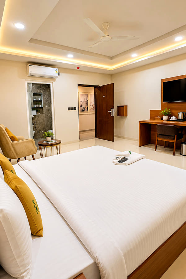 Jal Mahal Classic Room with a king bed, armchair and work desk at Lime Tree Hotel & Banquet, Jaipur