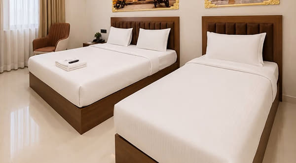 Jal Mahal Family Room with two beds and Rajasthani wall art at Lime Tree Hotel & Banquet, Jaipur