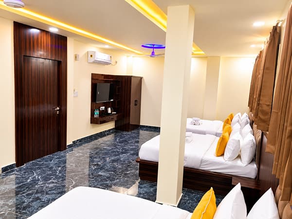 Family Suite with a TV unit, a wardrobe and beds at Lime Tree Hotel, Vrindavan