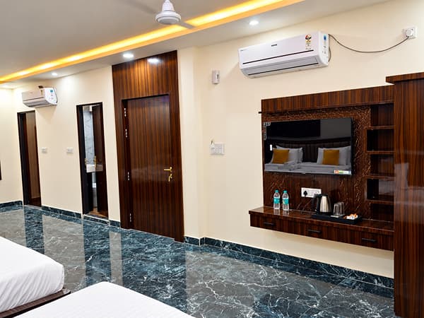 Family Suite TV unit with a kettle and water bottles at Lime Tree Hotel, Vrindavan