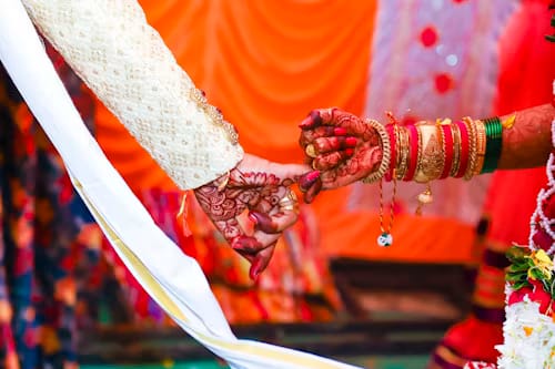 Bride and groom’s henna-adorned hands joined during the wedding rituals at Hotel Aarna Premier, Jaipur