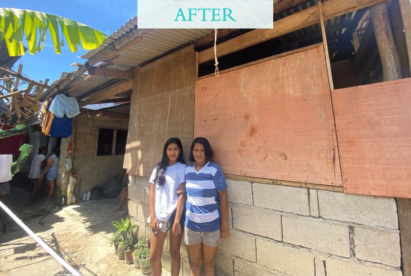 Two smiling women stand in front of a repaired house with new plywood siding, with an after label overlaid showing the completed rebuild