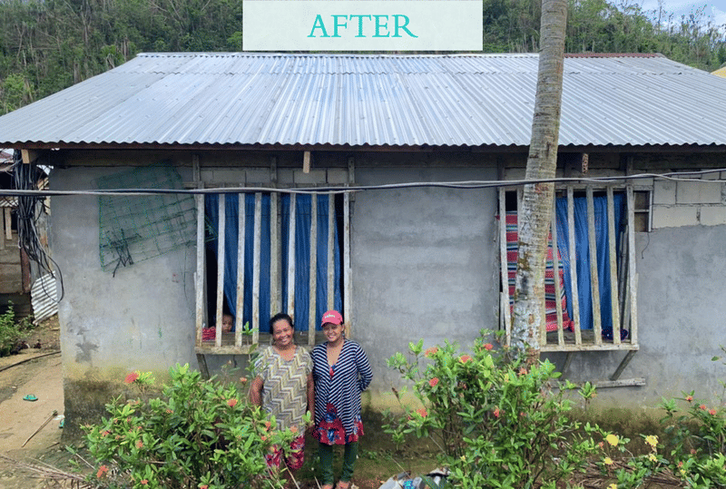Two women stand in front of a repaired house with a new corrugated roof and flowering shrubs, labeled AFTER, showing progress in a Siargao home rebuild