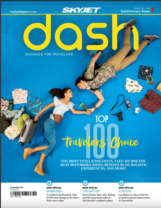 Cover of Dash magazine by SkyJet featuring a couple posed among travel items on a blue background, headlined Top 100 Travelers Choice with a Siargao feature