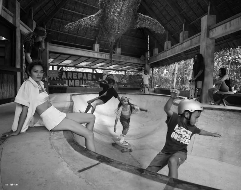 Black and white photo from Vogue Philippines of skaters in the concrete skate bowl at Bravo Beach Resort Siargao, with a thatched-roof pavilion overhead