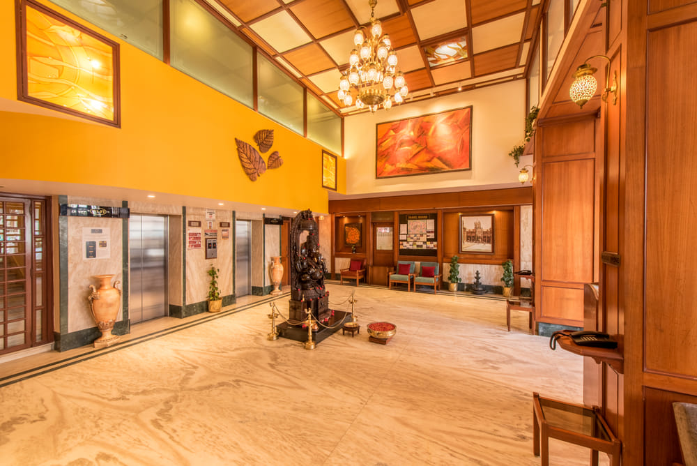 Grand lobby of Bangalore Gate Hotel, chandelier, Ganesha idol, and heritage paintings