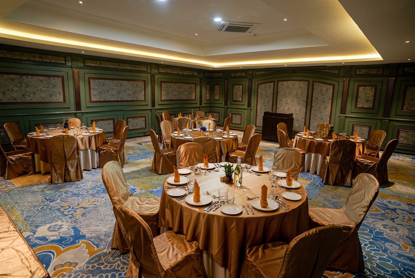 Serena banquet hall at RG Grand with round tables laid for dinner