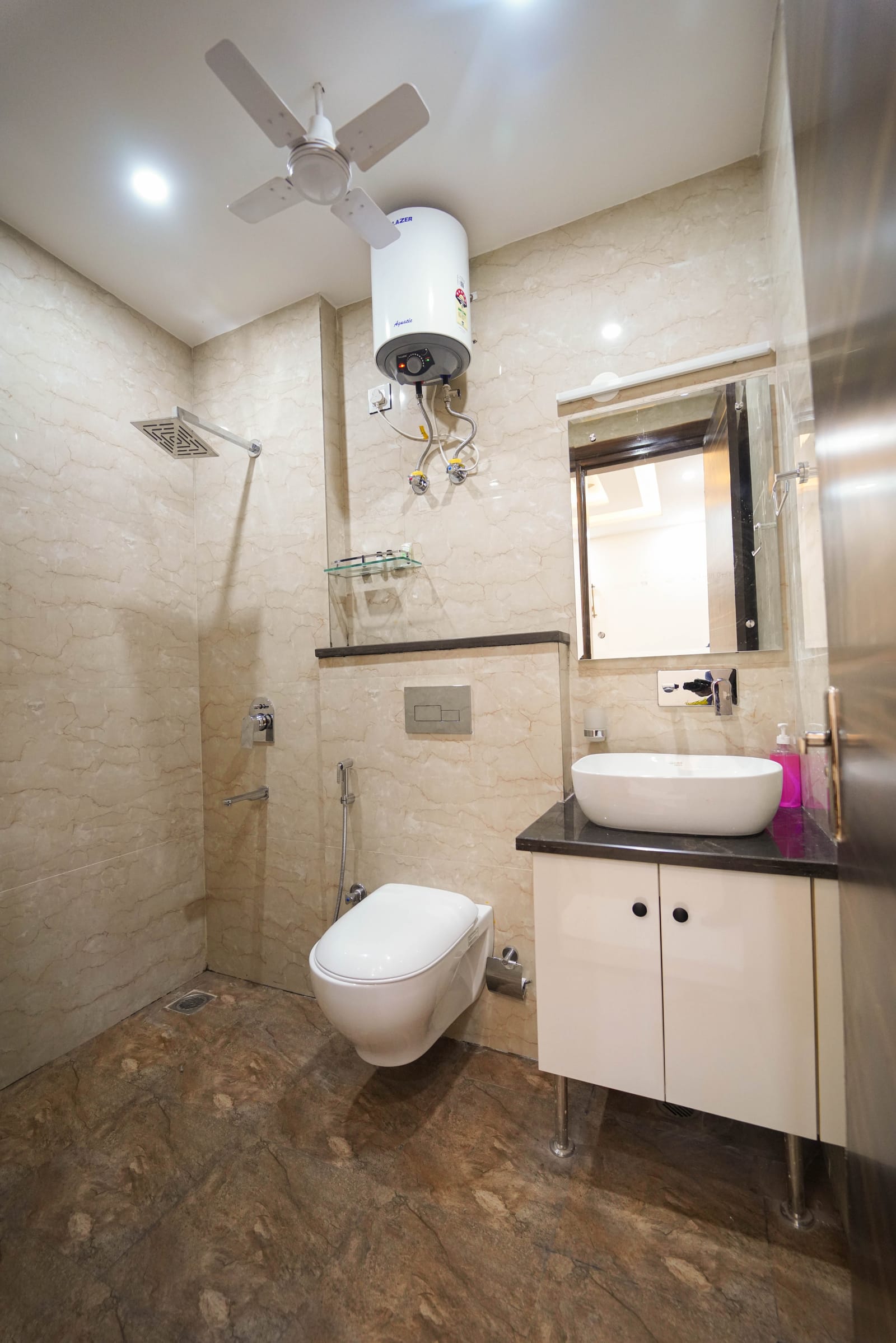 Bathroom with rain shower, wall-mounted toilet and vessel sink vanity at Lime Tree 2BHK Serviced Apartment, Golf Course Road