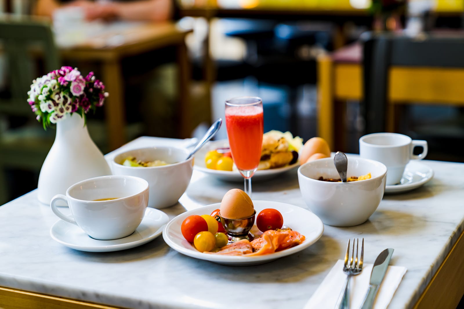 Breakfast table with eggs, fresh fruit, smoked salmon, juice and coffee cups at Lime Tree, Greater Kailash-2
