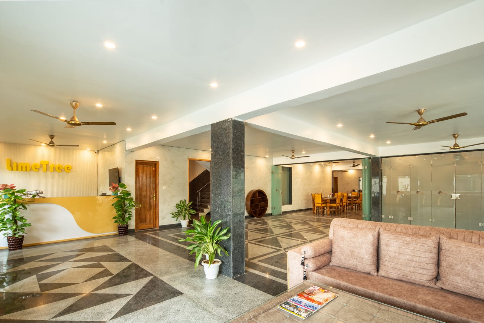 Lobby with reception desk, sofa seating and patterned tile floor at Lime Tree Hotel and 1BHK Serviced Apartment, Noida