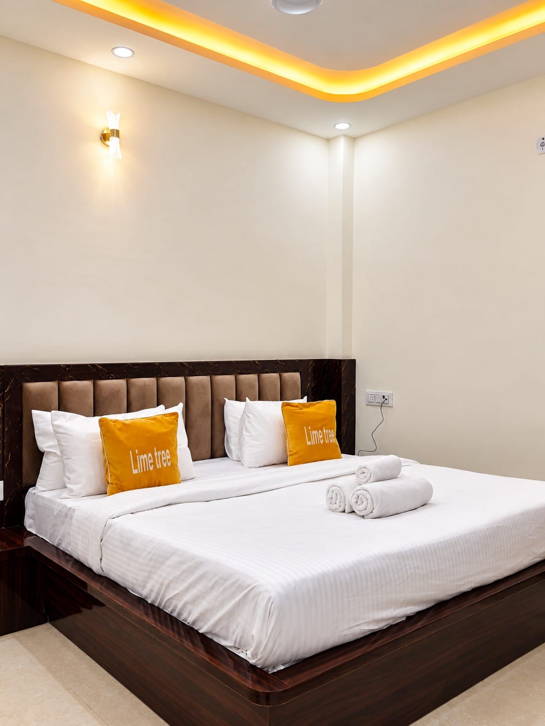 Deluxe Room king bed under a cove-lit ceiling at Lime Tree Hotel, Vrindavan
