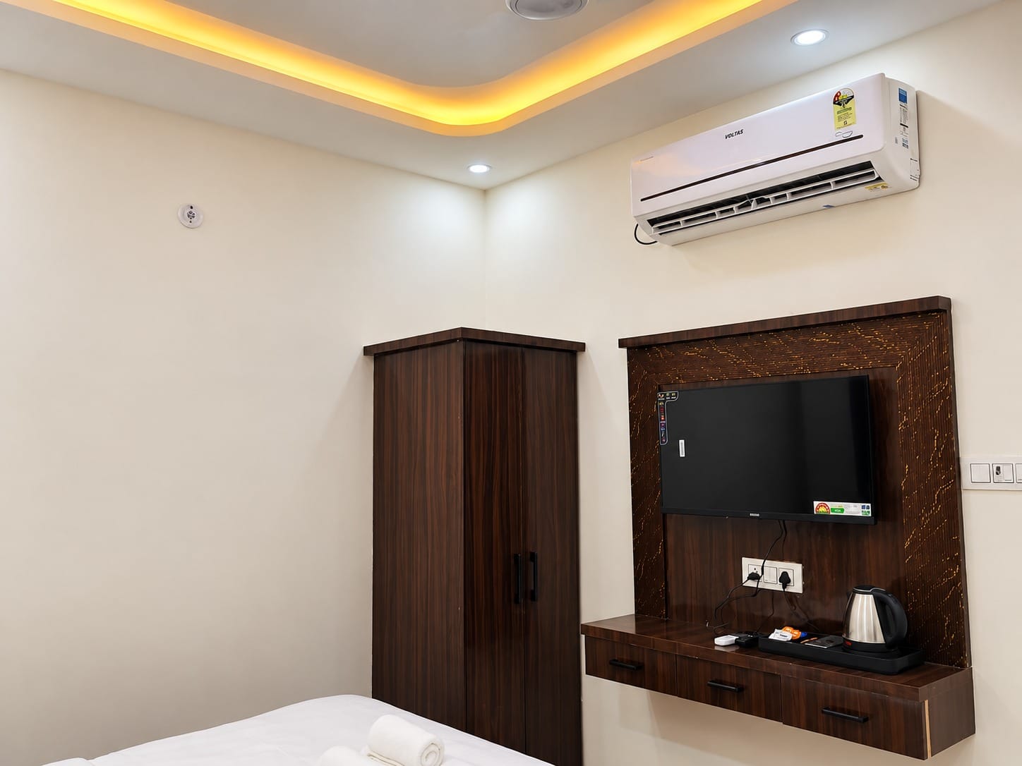 Deluxe Room wardrobe, TV unit and air conditioner at Lime Tree Hotel, Vrindavan