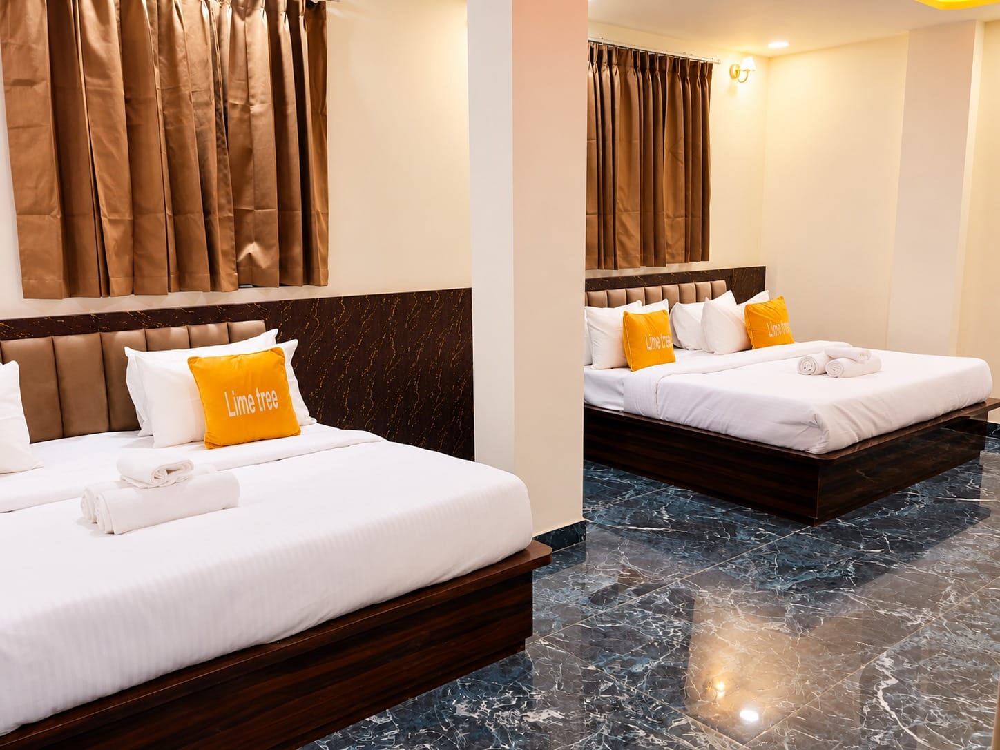 Two king beds with brown headboards in the Family Suite at Lime Tree Hotel, Vrindavan