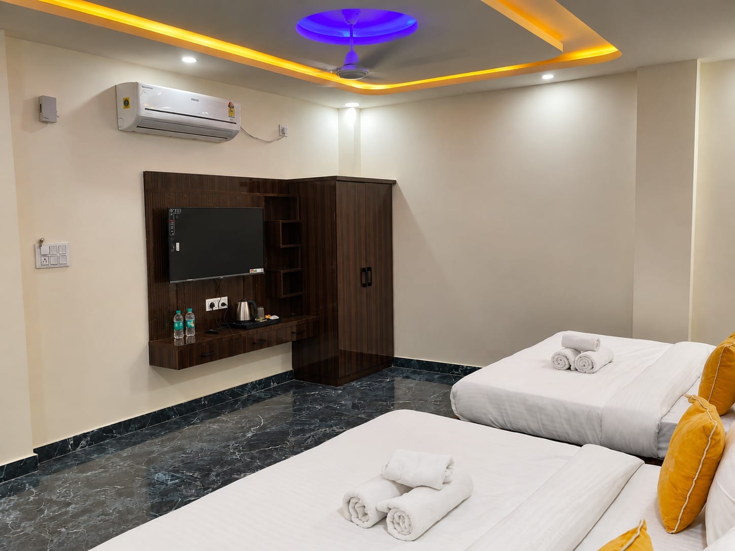 Family Suite TV unit and air conditioner beside the beds at Lime Tree Hotel, Vrindavan