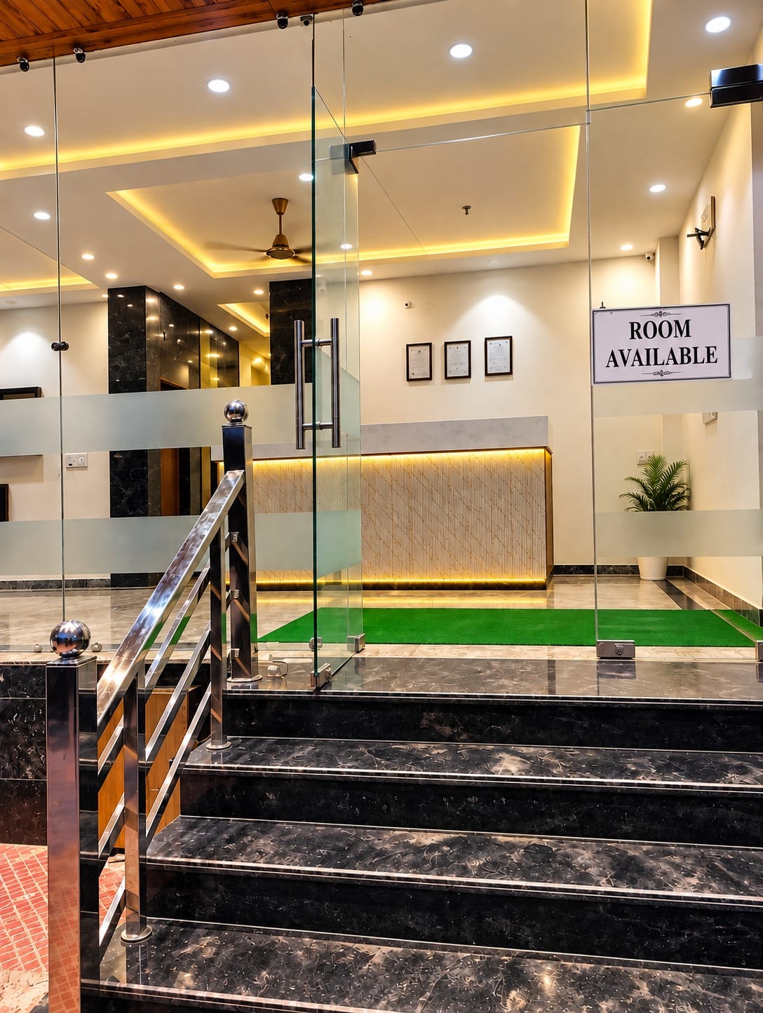 Glass entrance and steps leading to the reception at Lime Tree Hotel, Vrindavan