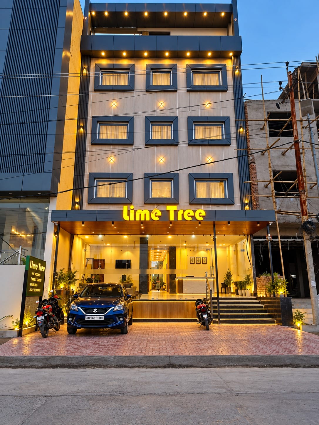 Facade of Lime Tree Hotel, Vrindavan lit up at night near Prem Mandir