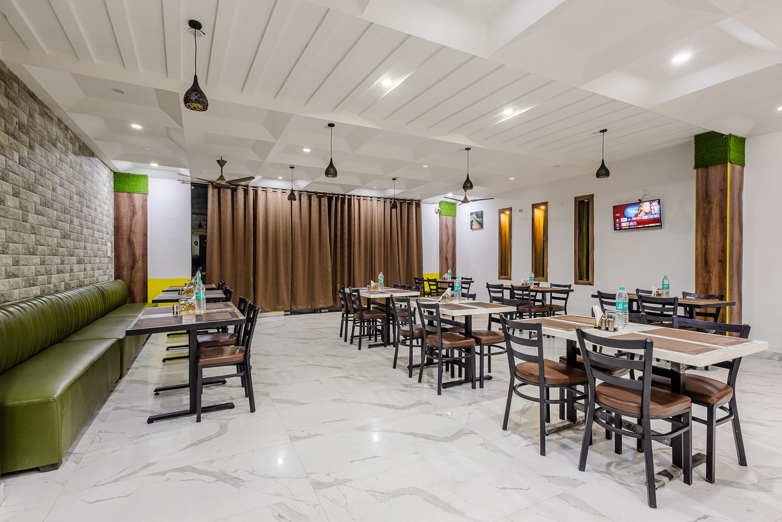 The indoor restaurant at Lime Tree Hotels and Banquet, Vrindavan with well defined seating area.