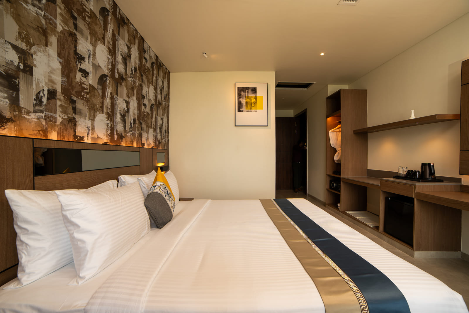 Deluxe King &mdash; The bed, with the wardrobe beyond