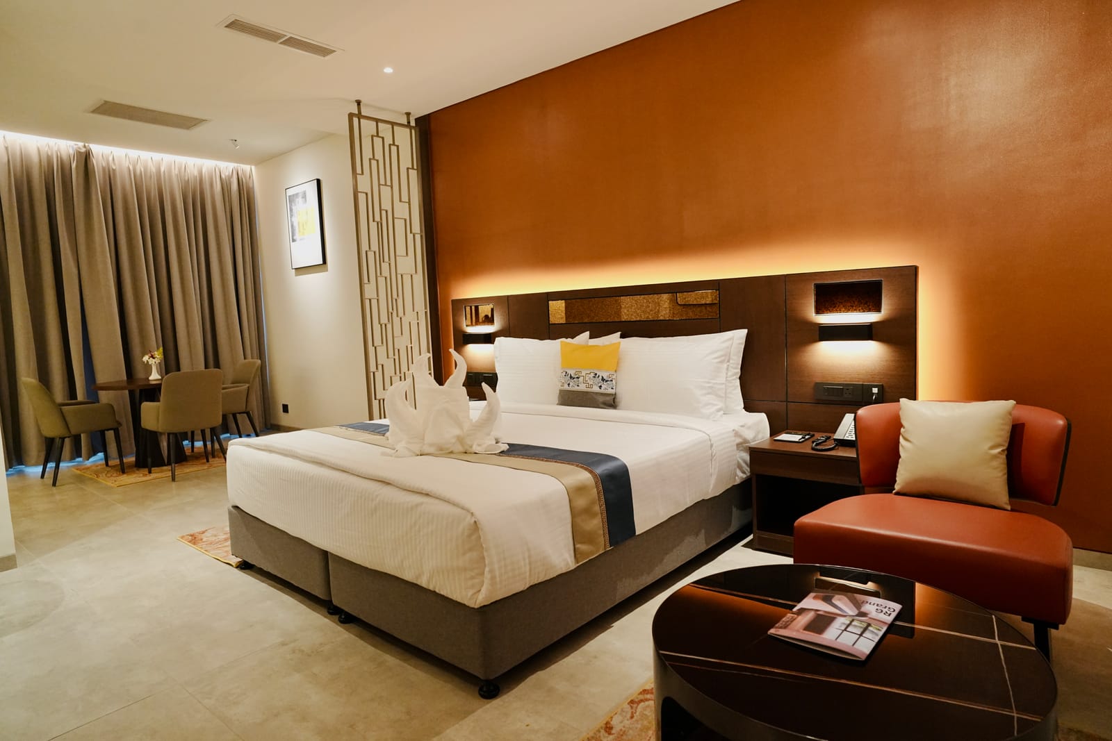 Deluxe Suite &mdash; The bed, with the writing desk beyond