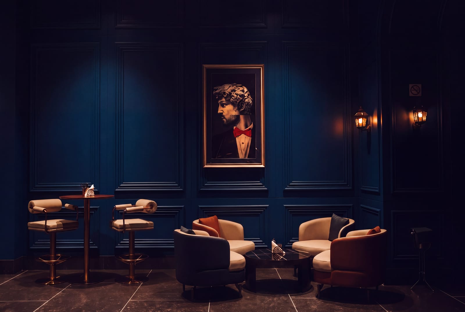 Cushioned armchairs around a low table, brass-legged bar stools and a framed portrait on a navy panelled wall at Azul Lounge & Bar, RG Grand Hotel & Convention.